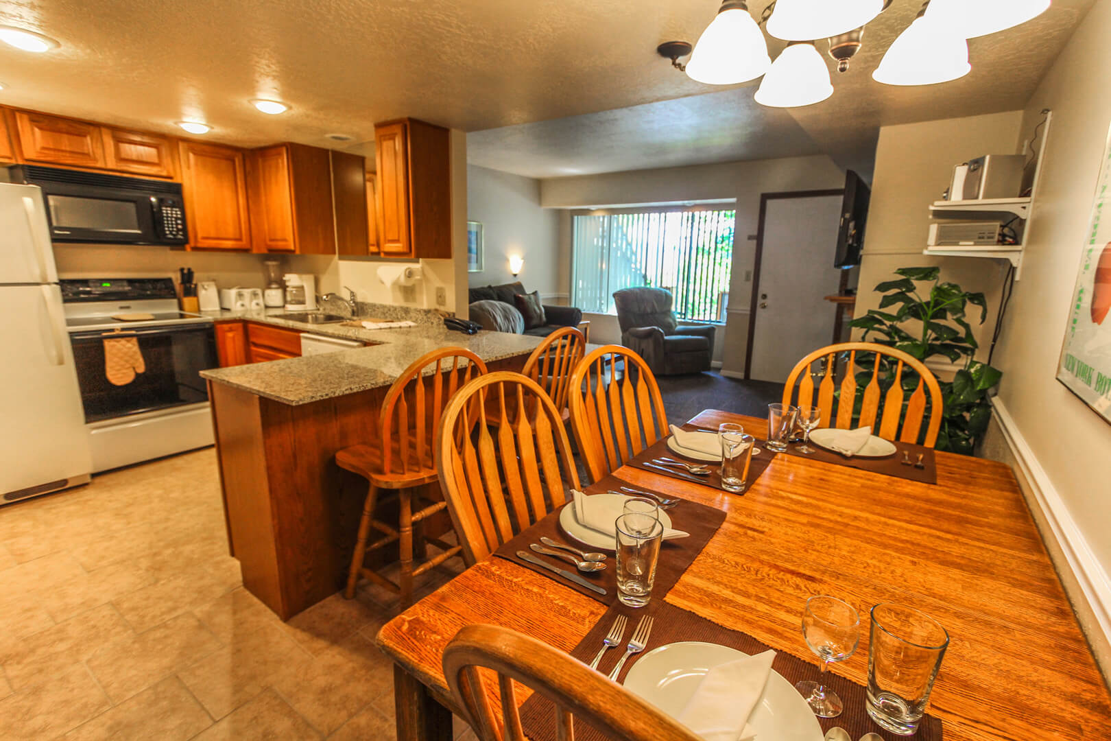 A spacious kitchen and dining room table at VRI's Wolf Creek Village I in Eden, Utah.